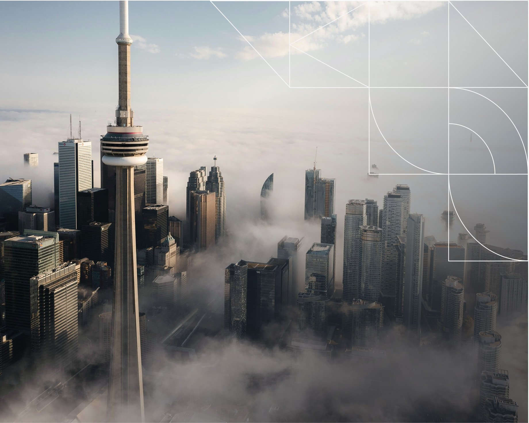 Aerial view of Toronto’s skyline with the CN Tower rising prominently above downtown skyscrapers, partially surrounded by low clouds or fog. The city buildings emerge through the mist under soft morning light, while faint geometric design lines overlay the upper-right corner of the image.